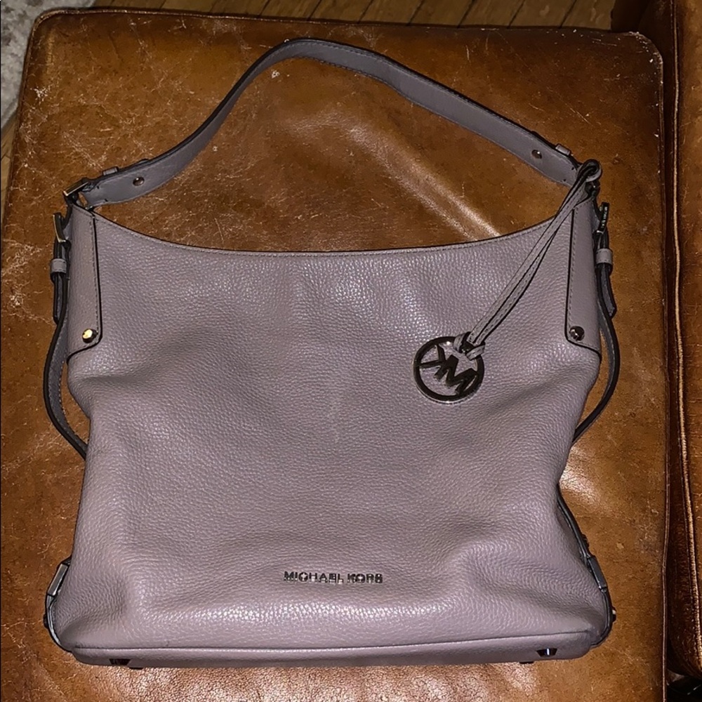 A gray Michael Kors purse and wallet barely used